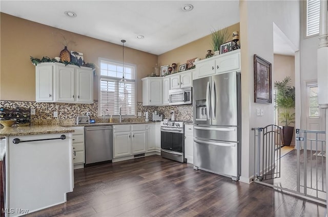8550 Ivy Hill Dr Unit 16, Poland, OH 44514 - kitchen with appliances with stainless steel finishes, dark wood-style floors, backsplash, white cabinetry, and recessed lighting