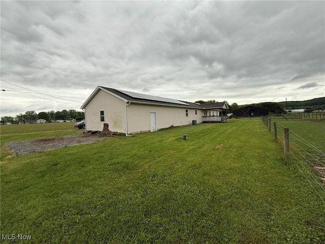 6920 Riverside Rd SE, Gnadenhutten, OH 44629 - view of home's exterior with solar panels and a wooden deck