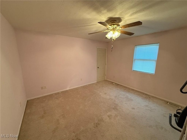 6920 Riverside Rd SE, Gnadenhutten, OH 44629 - empty room with a ceiling fan, baseboards, and carpet floors