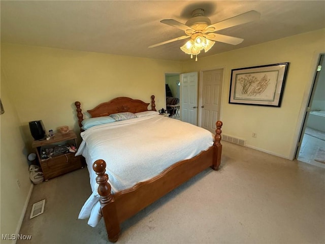 6920 Riverside Rd SE, Gnadenhutten, OH 44629 - bedroom with baseboards, carpet floors, ceiling fan, and connected bathroom