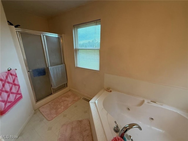 6920 Riverside Rd SE, Gnadenhutten, OH 44629 - full bathroom with a shower stall, a whirlpool tub, and baseboards