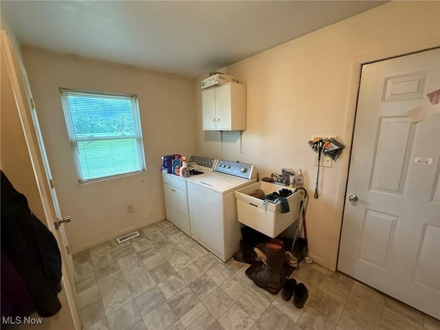 6920 Riverside Rd SE, Gnadenhutten, OH 44629 - laundry area featuring independent washer and dryer, cabinet space, and baseboards