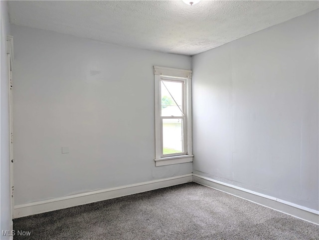 925 Camden Ave SW, Canton, OH 44706 - spare room with carpet flooring, a textured ceiling, and baseboards