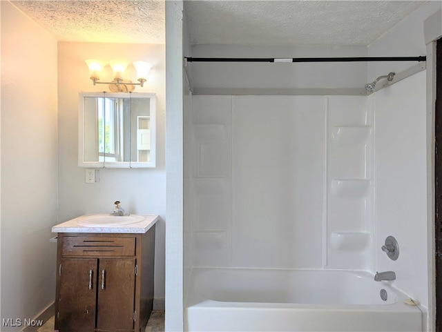 925 Camden Ave SW, Canton, OH 44706 - bathroom with a textured ceiling, vanity, tub / shower combination, and baseboards