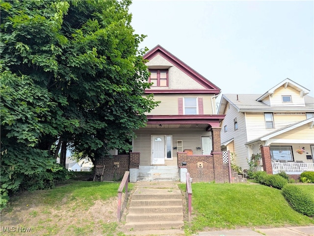 925 Camden Ave SW, Canton, OH 44706 - view of front of house featuring covered porch and a front lawn