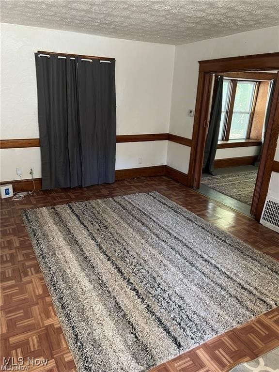 27 E Emerling Ave, Akron, OH 44301 - spare room with baseboards and a textured ceiling