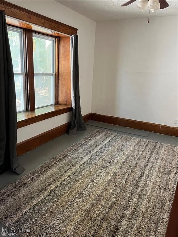 27 E Emerling Ave, Akron, OH 44301 - empty room featuring a ceiling fan and baseboards