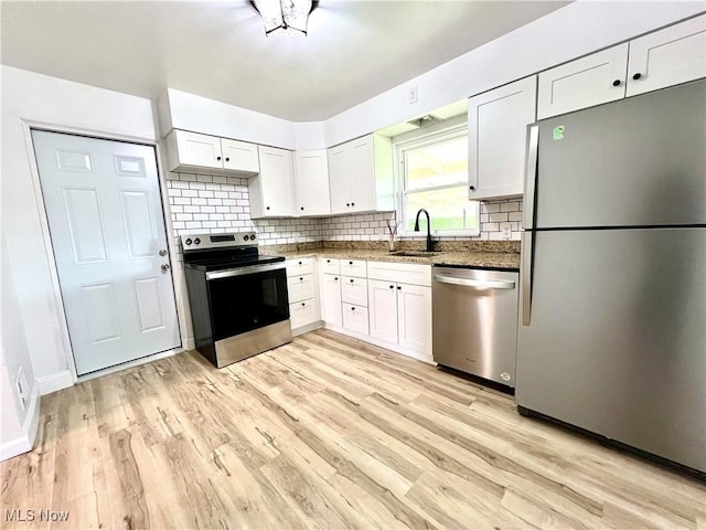 281 Hillcrest Dr, Wellsburg, WV 26070 - kitchen with stainless steel appliances, a sink, backsplash, white cabinetry, and light wood-style flooring