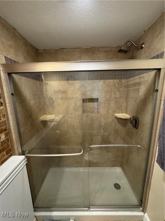 208 Walton Ave, Barnesville, OH 43713 - full bathroom featuring a textured ceiling, a shower stall, and toilet