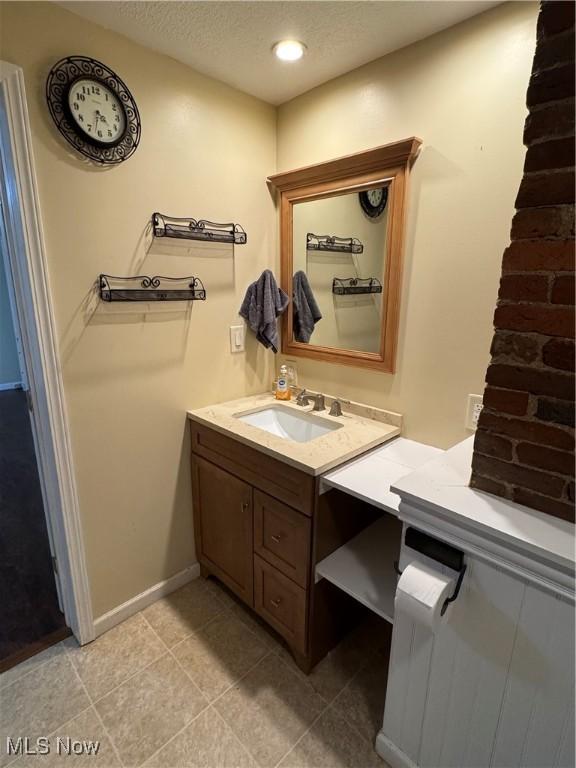 208 Walton Ave, Barnesville, OH 43713 - bathroom featuring vanity, baseboards, a textured ceiling, tile patterned floors, and recessed lighting
