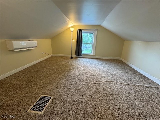 208 Walton Ave, Barnesville, OH 43713 - additional living space with an AC wall unit, lofted ceiling, baseboards, and carpet floors