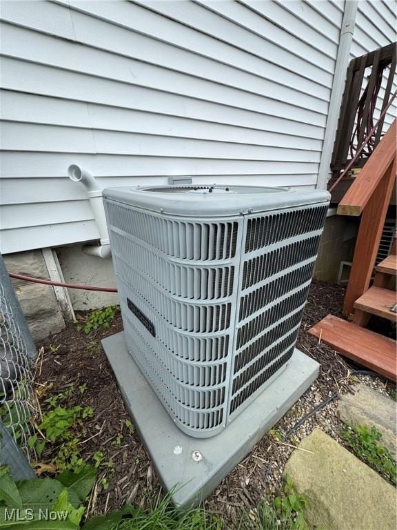 208 Walton Ave, Barnesville, OH 43713 - exterior view of central air condition unit and stairway