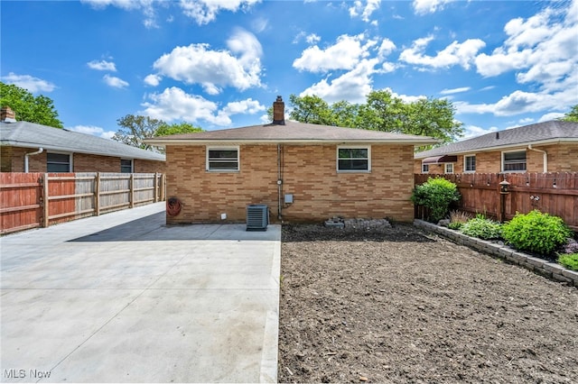 4482 W 144th St, Cleveland, OH 44135 - rear view of property featuring a patio, a chimney, and brick siding