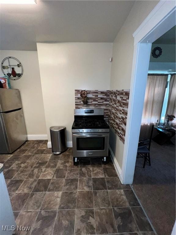 10010 Parmelee Ave, Cleveland, OH 44108 - kitchen featuring stainless steel appliances, baseboards, and stone finish flooring