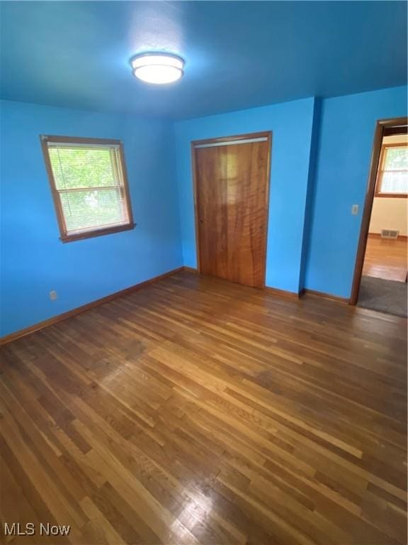 1414 W 40th St, Lorain, OH 44053 - unfurnished bedroom featuring hardwood / wood-style floors, a closet, and baseboards