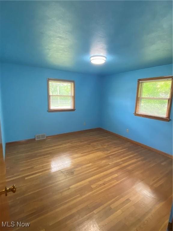 1414 W 40th St, Lorain, OH 44053 - unfurnished room featuring healthy amount of natural light, wood finished floors, and baseboards