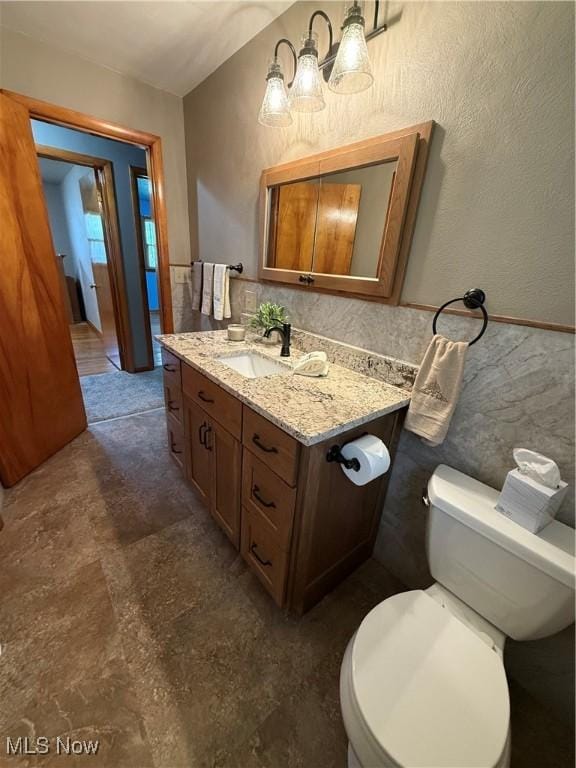 1414 W 40th St, Lorain, OH 44053 - half bath featuring vanity, toilet, and a textured wall