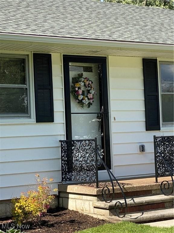 1414 W 40th St, Lorain, OH 44053 - property entrance featuring roof with shingles and a porch