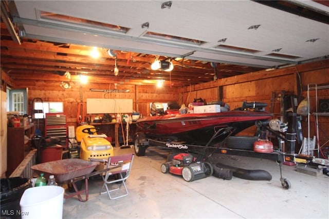 14201 Kauffman Ave, Sterling, OH 44276 - garage featuring a garage door opener and a workshop area