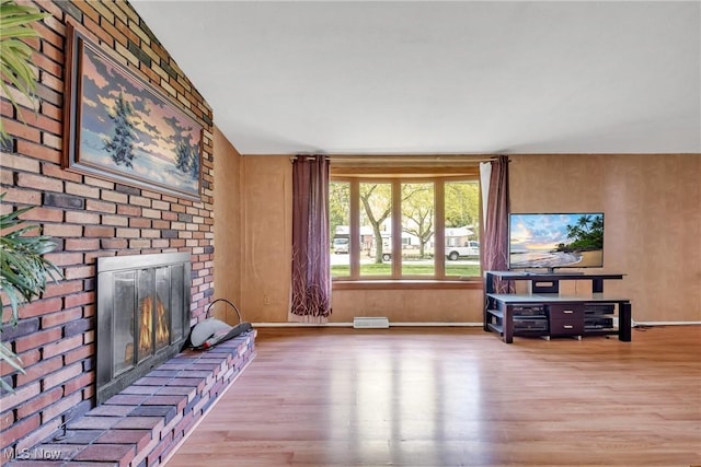 6221 Brighton Dr, North Olmsted, OH 44070 - unfurnished living room with wood finished floors, a brick fireplace, and baseboards