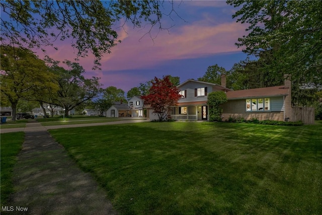 6221 Brighton Dr, North Olmsted, OH 44070 - traditional home featuring a yard, a chimney, and covered porch
