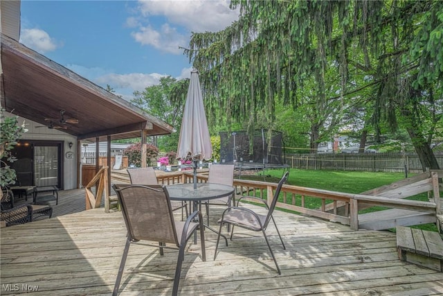6221 Brighton Dr, North Olmsted, OH 44070 - wooden terrace featuring a trampoline and outdoor dining area