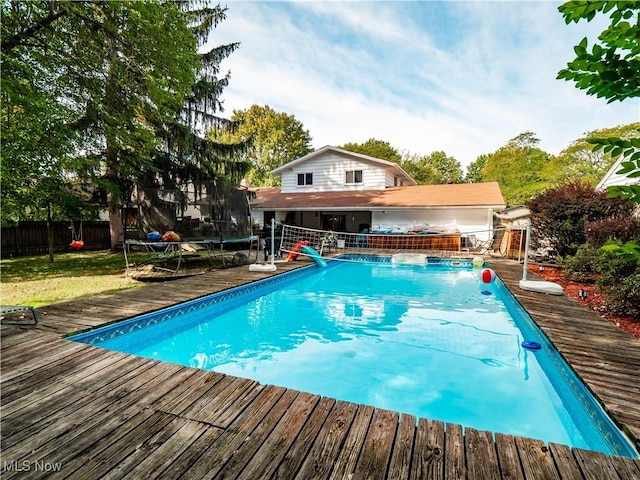 6221 Brighton Dr, North Olmsted, OH 44070 - view of pool with a trampoline and a wooden deck