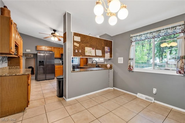 6221 Brighton Dr, North Olmsted, OH 44070 - kitchen with refrigerator with ice dispenser, light tile patterned floors, a ceiling fan, a chandelier, and a sink