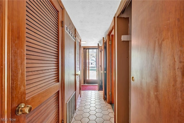 6221 Brighton Dr, North Olmsted, OH 44070 - hall featuring a textured ceiling and light tile patterned flooring