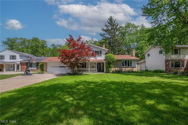 6221 Brighton Dr, North Olmsted, OH 44070 - view of front of home featuring an attached garage, a porch, driveway, a front lawn, and a chimney
