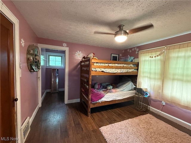 7350 Center Rd, Saybrook, OH 44004 - bedroom featuring a textured ceiling, wood finished floors, baseboards, and ceiling fan