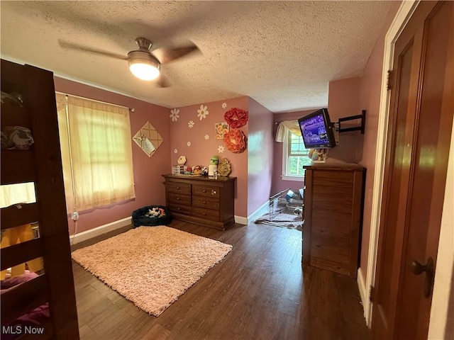 7350 Center Rd, Saybrook, OH 44004 - bedroom featuring dark wood-type flooring, baseboards, a textured ceiling, and ceiling fan