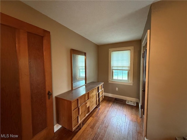 7350 Center Rd, Saybrook, OH 44004 - interior space with dark wood-style floors, baseboards, and a textured ceiling