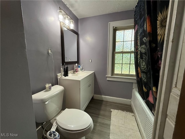 7350 Center Rd, Saybrook, OH 44004 - full bath featuring toilet, vanity, wood finished floors, baseboards, and shower / tub combo with curtain