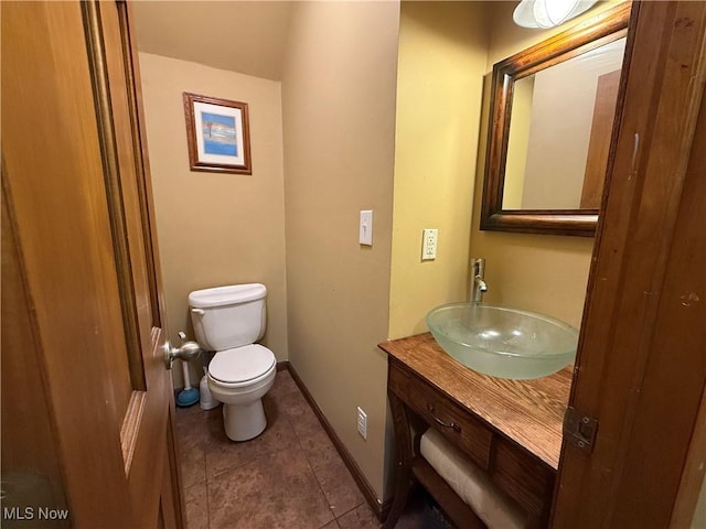 7350 Center Rd, Saybrook, OH 44004 - bathroom featuring toilet, vanity, tile patterned floors, and baseboards