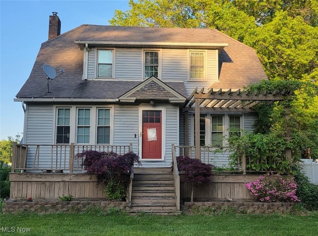 7350 Center Rd, Saybrook, OH 44004 - view of front of property with a chimney, a pergola, and roof with shingles