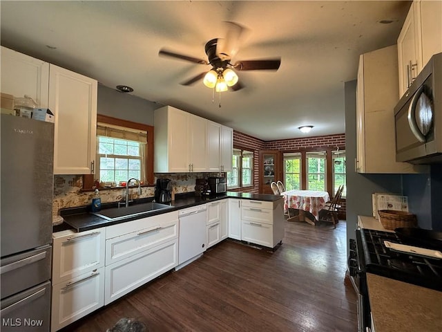 7350 Center Rd, Saybrook, OH 44004 - kitchen featuring dishwasher, freestanding refrigerator, a sink, range with gas cooktop, and a ceiling fan