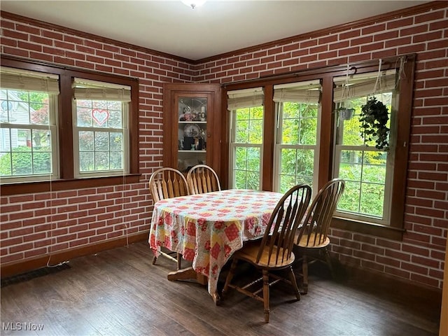 7350 Center Rd, Saybrook, OH 44004 - dining space featuring brick wall and wood-type flooring