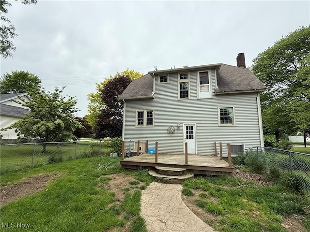 7350 Center Rd, Saybrook, OH 44004 - back of property featuring a chimney, a deck, and a shingled roof