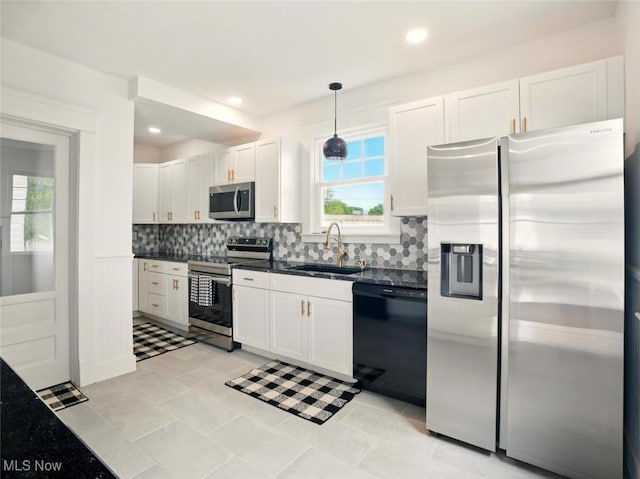 1433 W 4th St, Ashtabula, OH 44004 - kitchen with appliances with stainless steel finishes, a sink, dark countertops, tasteful backsplash, and recessed lighting