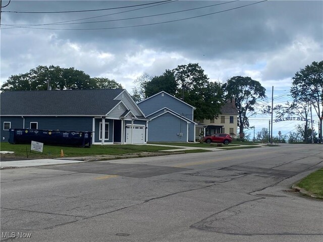 1433 W 4th St, Ashtabula, OH 44004 - view of front of home featuring an attached garage, concrete driveway, and a front lawn