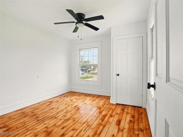 1433 W 4th St, Ashtabula, OH 44004 - unfurnished bedroom featuring light wood-style flooring, baseboards, and ceiling fan