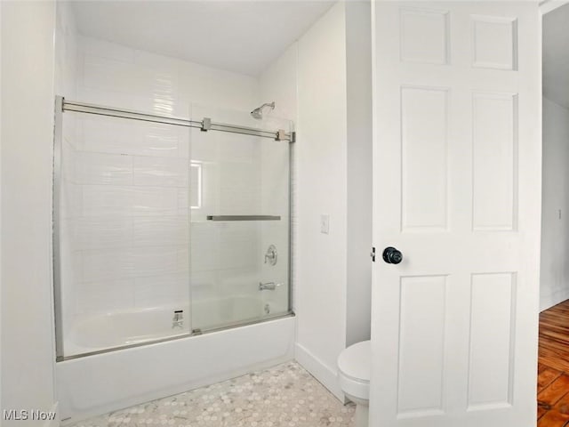 1433 W 4th St, Ashtabula, OH 44004 - full bath featuring shower / bath combination with glass door, toilet, and baseboards