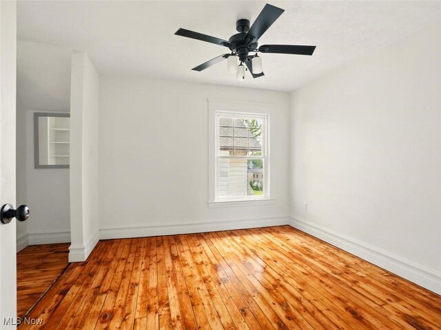 1433 W 4th St, Ashtabula, OH 44004 - spare room featuring wood-type flooring, baseboards, and ceiling fan