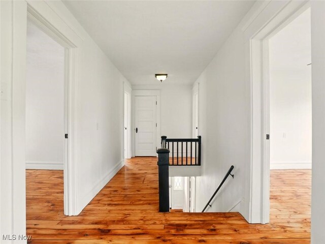1433 W 4th St, Ashtabula, OH 44004 - hallway with an upstairs landing, wood finished floors, and baseboards