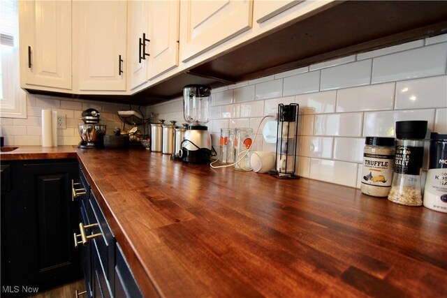 615 Wolf Ave, Wadsworth, OH 44281 - kitchen featuring butcher block countertops, tasteful backsplash, and wood finished floors