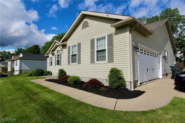 615 Wolf Ave, Wadsworth, OH 44281 - view of side of property featuring concrete driveway, an attached garage, and a lawn