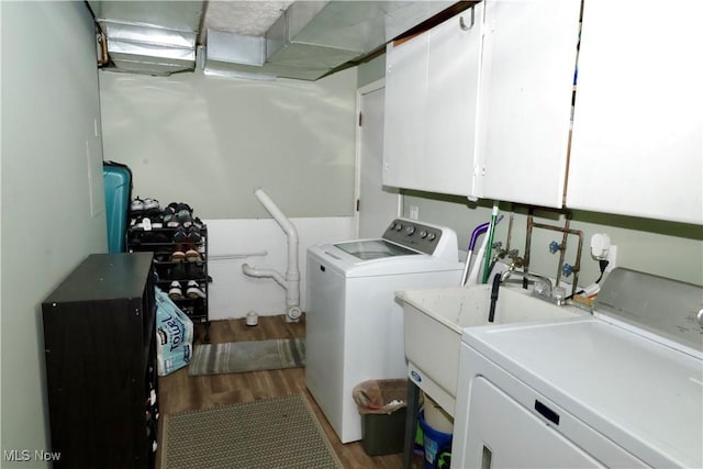 5430 Barkwood Dr, Sheffield Village, OH 44054 - laundry area featuring separate washer and dryer, cabinet space, and wood finished floors