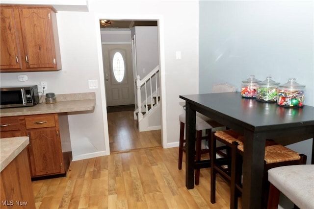 5430 Barkwood Dr, Sheffield Village, OH 44054 - dining room featuring light wood finished floors, baseboards, and stairs