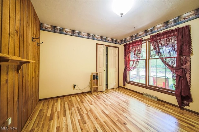 12793 New London Eastern Rd, Spencer, OH 44275 - spare room with light wood-style floors, baseboards, and wood walls